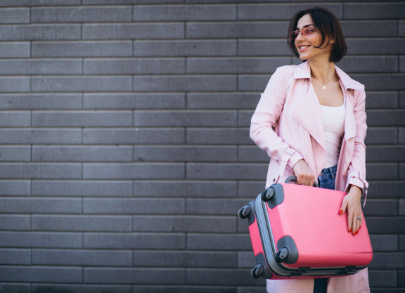 woman-travelling-pink-bag_1303-9581